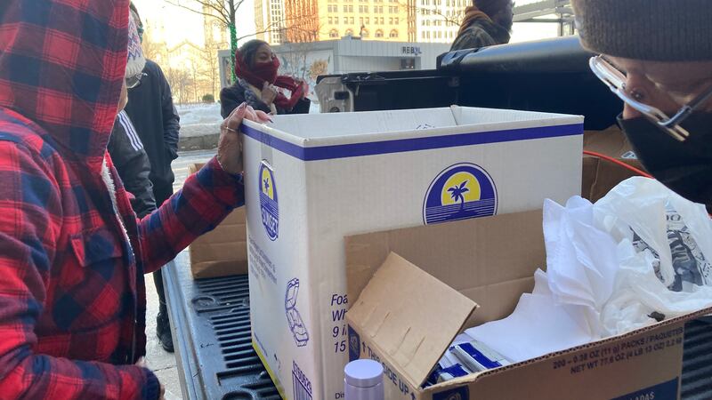 Denise Crisp and other volunteers give out homemade soup and sandwiches to hungry and...